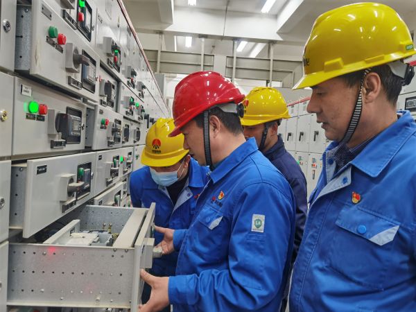 3月16日，對標(biāo)交流現(xiàn)場，大家圍在一起對配電室開關(guān)柜查找差距與優(yōu)勢.jpg